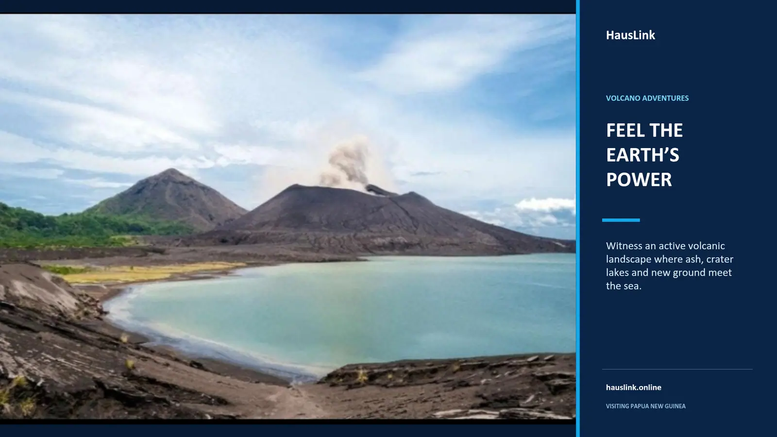 An active Papua New Guinea volcano venting ash above a crater bay of pale turquoise water.